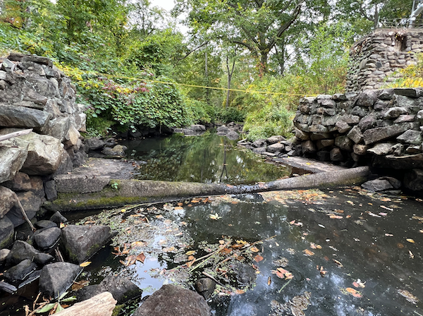 There is very little water flowing over the weir at the center of this photo.