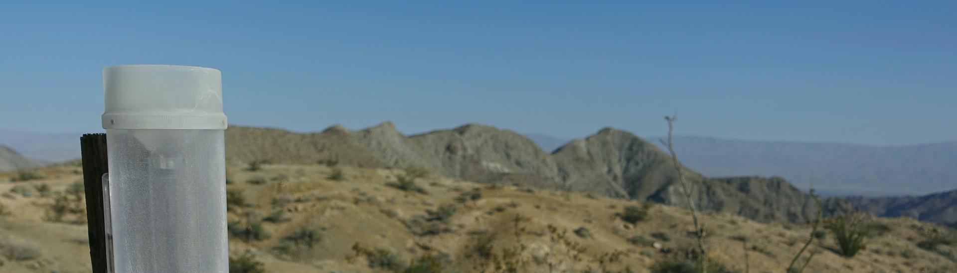 An empty rain gauge in a desert